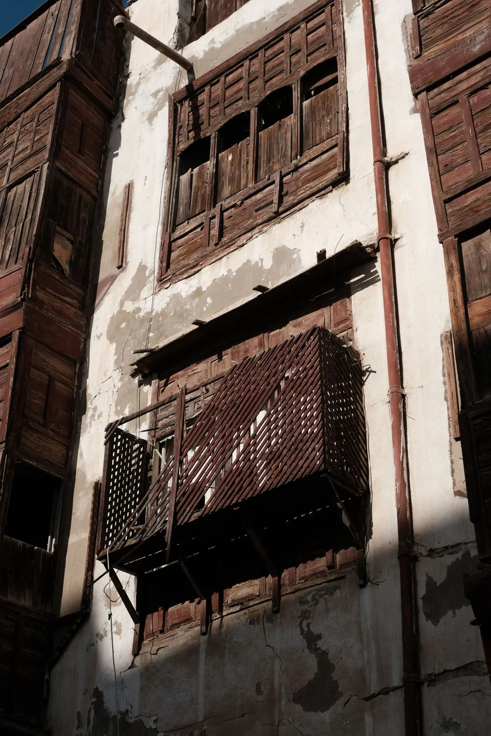 Close view of projecting wooden window screens on an old Jeddah house.
