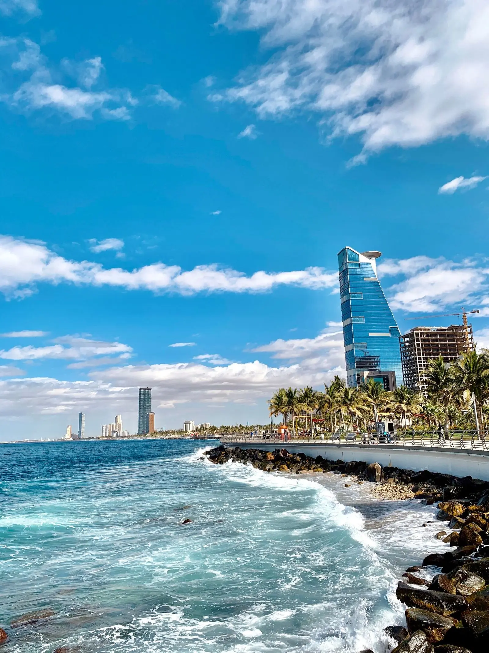 Modern towers and a construction crane along the Jeddah shoreline.